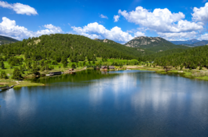 Evergreen Colorado summer — Evergreen Lake with paddleboards and mountain views